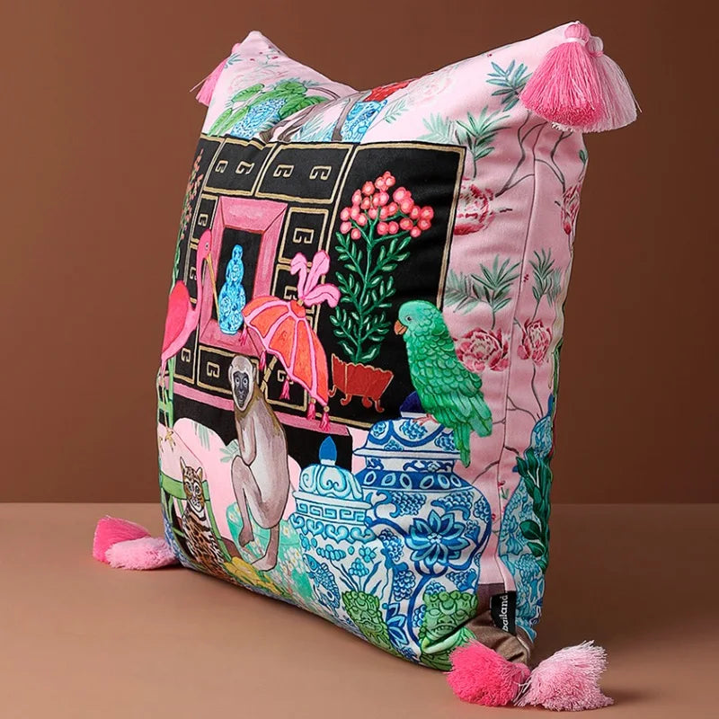 Housse de Coussin Rose Fushia avec une illustration détaillée incluant un flamant rose, un singe, un léopard, des plantes et des éléments décoratifs bleus et blancs - de coté