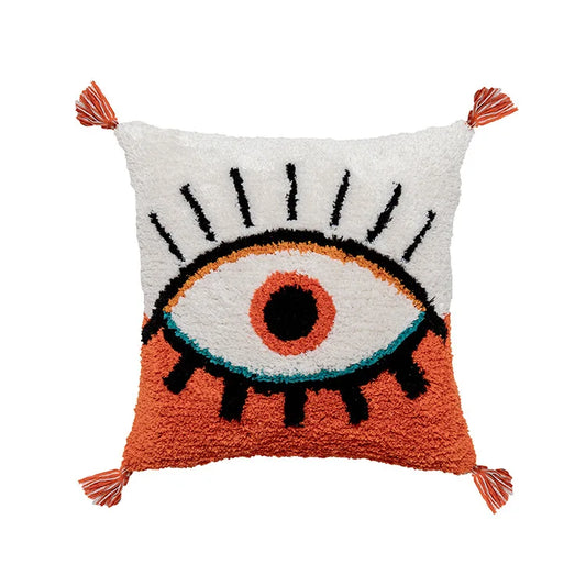 Housse de Coussin Orange et Blanc avec un design abstrait et moderne, présentant un motif d'œil central avec iris orange et contour bleu, rayons noirs et pompons aux coins - de face